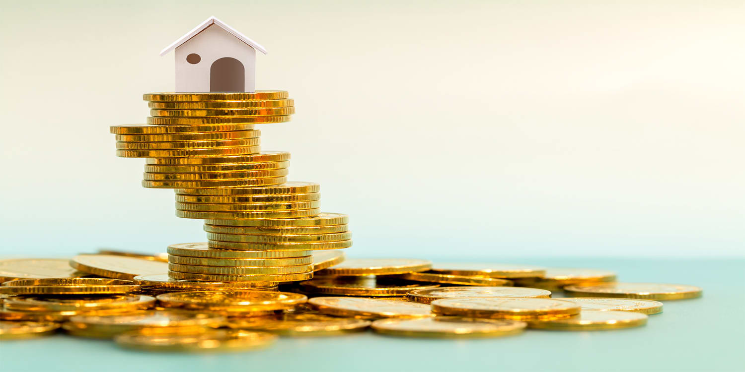 House on stack of coins, concept for financing investment properties